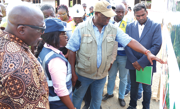 Kwasi Amoako-Atta (3rd from left), Minister of Roads and Highways, with technical staff at the the Dome-Kitase road project site